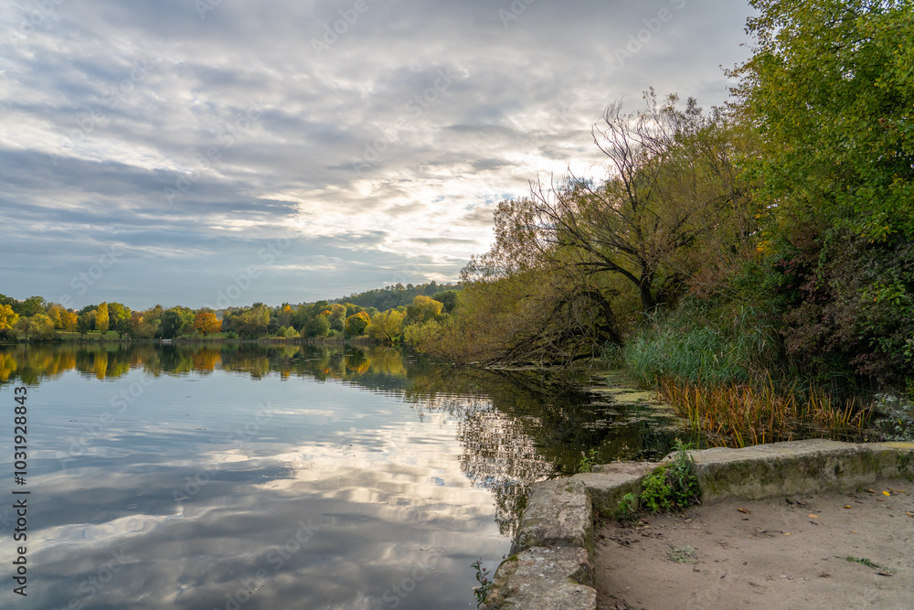Vibrant Autumn Trees Turning Orange and Yellow by Max-Eyth Lake in Stuttgart Vibrant Autumn Trees Turning Orange and Yellow by Max-Eyth Lake in Stuttgart