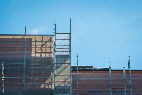 Scaffold sheeting net wrapped apartments building during insulation in england uk photo