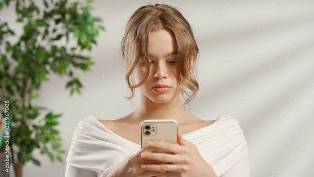 Tired woman with smartphone at office desk. Bureaucracy business concept. Tired woman with smartphone at office desk. Bureaucracy business concept.