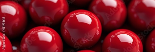 Close up view of shiny red balls arranged neatly on a flat surface during day...