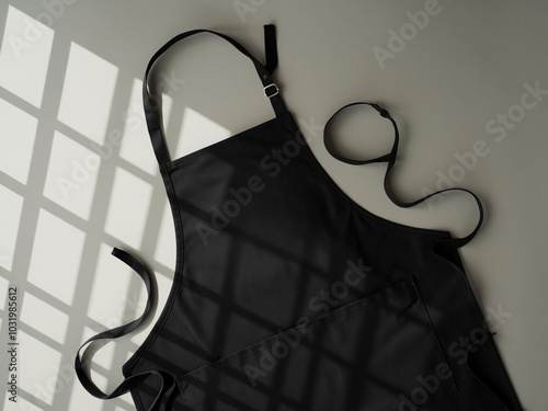 Blank black baker chef apron mockup for professional kitchen staff front view with adjustable ss
