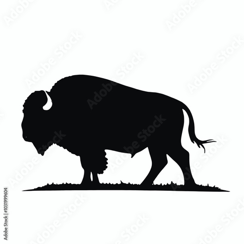 A black silhouette of a bison standing in a grassy field 