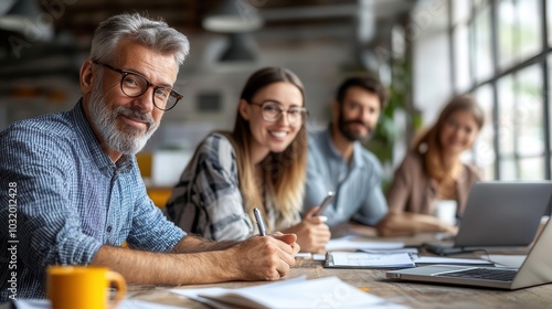 Age-diverse team collaborating in an open office, promoting inclusivity and eliminating ageism, workplace diversity