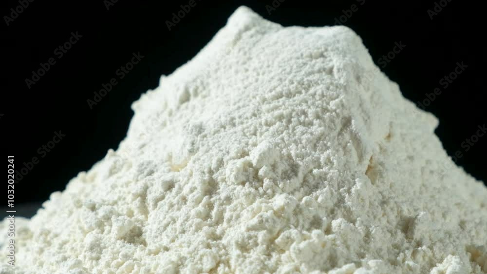 Macro rotation of white wheat flour on black background. Macro rotation of white wheat flour on black background.