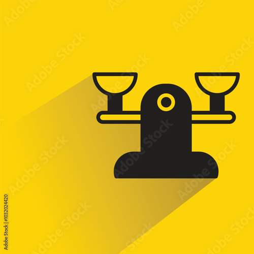 balance scales icon with shadow on yellow background