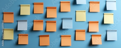 Colorful sticky notes arranged on a blue background with black paper clips