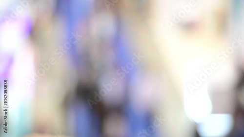 Intentionally blurred footage of people visiting pavilions and booths during a business trade fair 