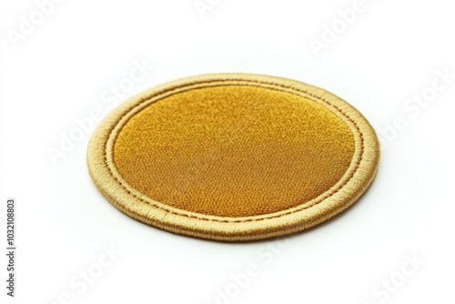 A single gold coin resting on a white surface, ready for inspection or counting