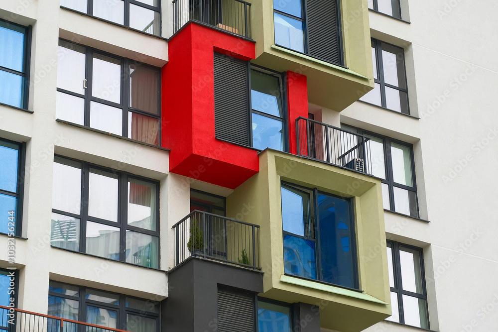 A modern apartment building with colorful balconies A modern apartment building with colorful balconies