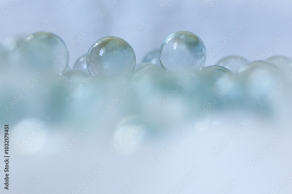 clear Glass marbles on a white background, close-up, selective focus clear Glass marbles on a white background, close-up, selective focus