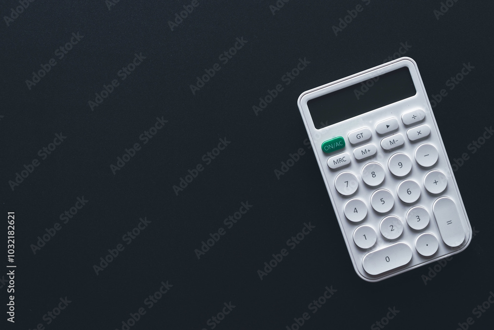 Calculator,money,mortgage,property concept.,Flat lay top view of white calculator over black background with copyspace suitable for business,financial,tax,mathematics,investment idea. Calculator,money,mortgage,property concept.,Flat lay top view of white calculator over black background with copyspace suitable for business,financial,tax,mathematics,investment idea.