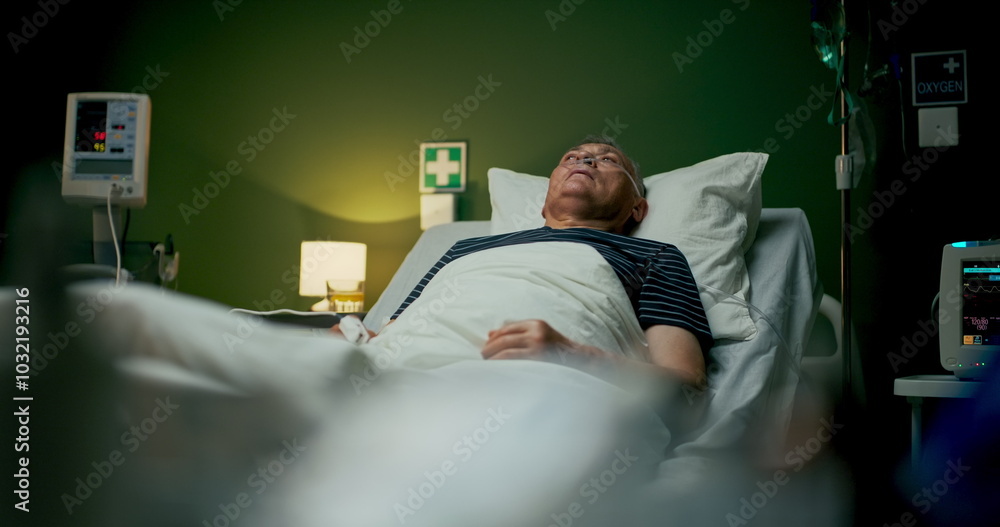 Elderly man lies in a hospital room, receiving oxygen therapy to support his breathing during recovery. Elderly man lies in a hospital room, receiving oxygen therapy to support his breathing during recovery.