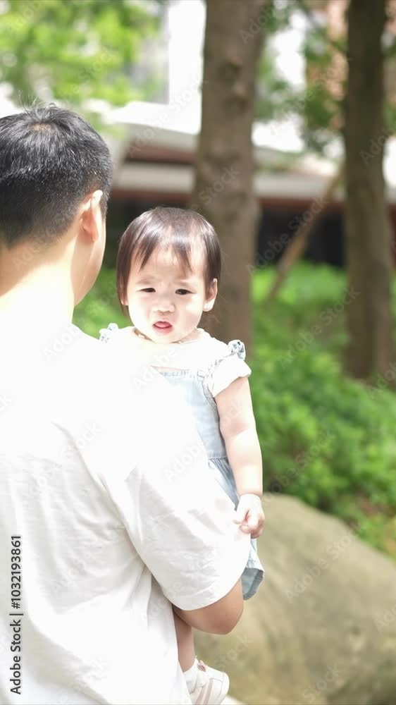 A Taiwanese family, consisting of a father in his 30s, a mother in her 20s, and their 1-year-old daughter, are walking apartment in Taichung City, Taiwan.Slowmotion, Vertical Video. A Taiwanese family, consisting of a father in his 30s, a mother in her 20s, and their 1-year-old daughter, are walking apartment in Taichung City, Taiwan.Slowmotion, Vertical Video.