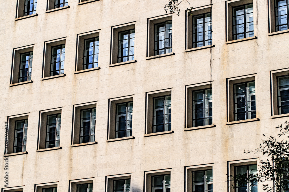Fototapeta premium Symmetrical Windows on a Modern Beige Building Facade