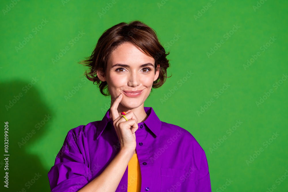 Portrait photo of young intelligent young cute lady in purple shirt touch chin cunning thinking isolated on green color background Portrait photo of young intelligent young cute lady in purple shirt touch chin cunning thinking isolated on green color background