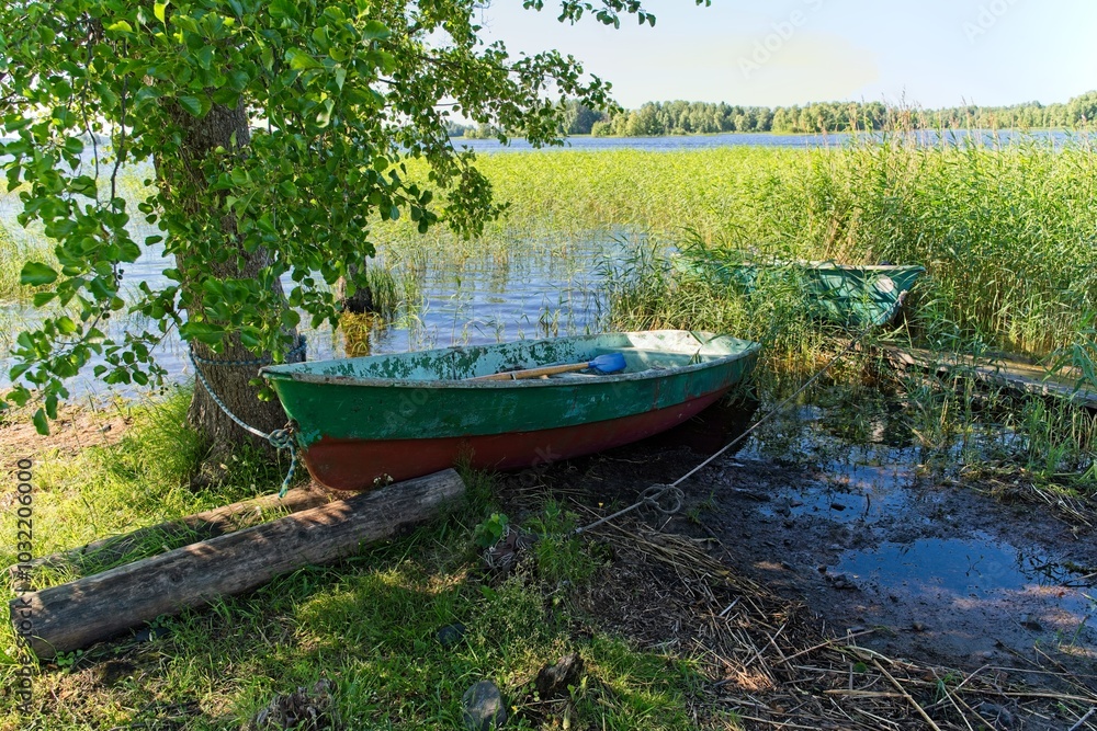 Kizhi Island, Russia, July 10, 2024. Boats in shallow water among the reeds. Kizhi Island, Russia, July 10, 2024. Boats in shallow water among the reeds.