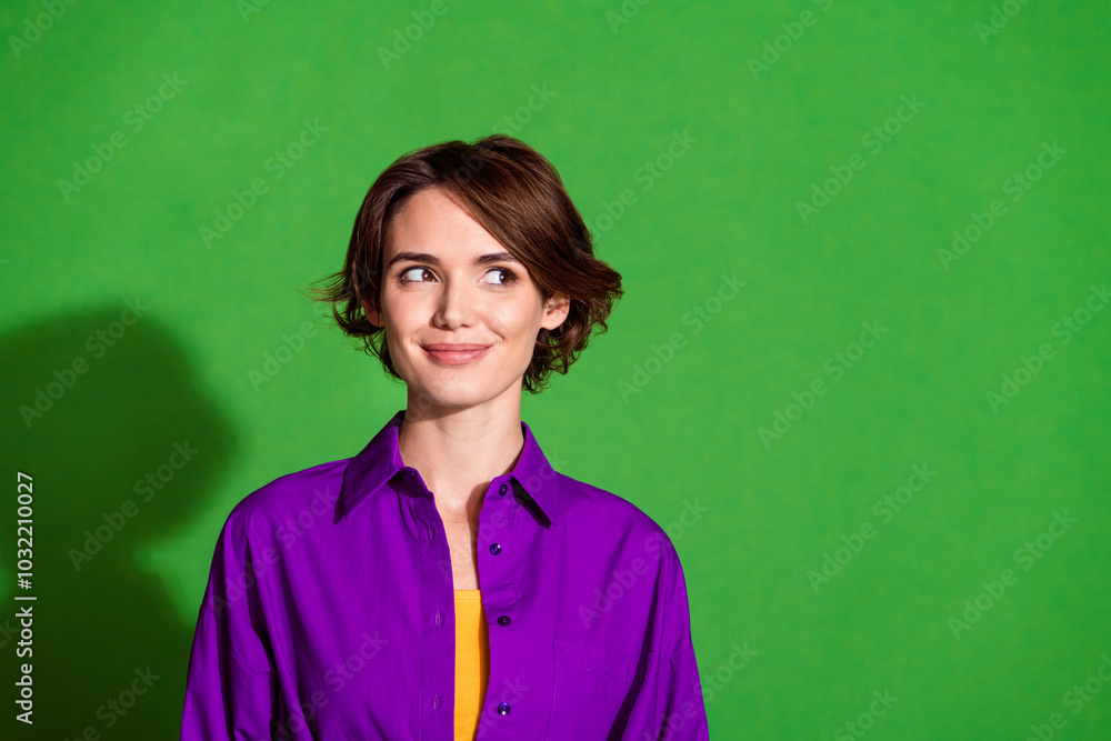 Photo portrait of funny young woman in purple stylish shirt and brown bob haircut minded looking empty space isolated on green color background Photo portrait of funny young woman in purple stylish shirt and brown bob haircut minded looking empty space isolated on green color background