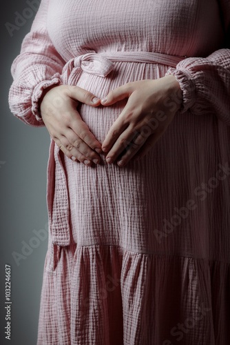 A pregnant woman in the arms of her husband. Summer sunny weather. A couple in love are hugging. Future parents. Young mom. Happy addition to the family. The concept of clothes for pregnant women.