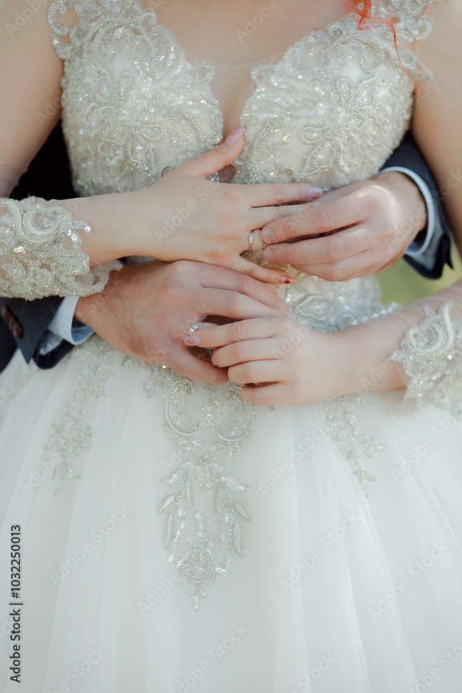 A couple in love touches each other with their hands. Love story of a young couple in love. Wedding rings on ring fingers. The newlyweds exchange rings A couple in love touches each other with their hands. Love story of a young couple in love. Wedding rings on ring fingers. The newlyweds exchange rings