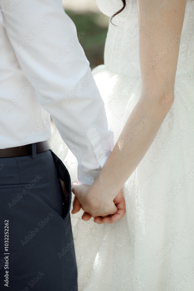 A couple in love touches each other with their hands. Love story of a young couple in love. Wedding rings on ring fingers. Concept of a marriage proposal. Starting a family. A couple in love touches each other with their hands. Love story of a young couple in love. Wedding rings on ring fingers. Concept of a marriage proposal. Starting a family.