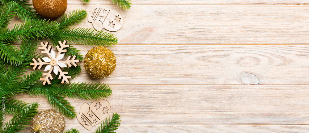Set of festive balls, fir tree and Christmas decorations on wooden background. Top view of New Year ornament concept with copy space Set of festive balls, fir tree and Christmas decorations on wooden background. Top view of New Year ornament concept with copy space