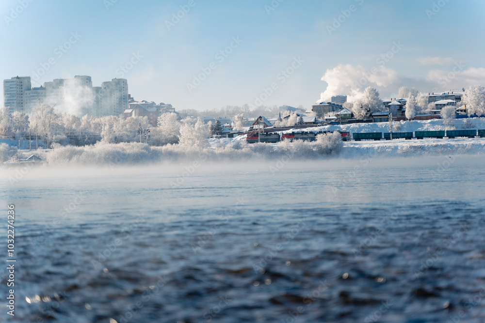 Winter frosty evaporation from the river in cold weather. Winter frosty evaporation from the river in cold weather.