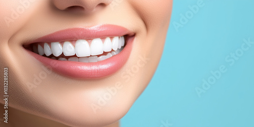 The gleaming white teeth of a womanâs beaming smile, standing out sharply against a softly blurred blue background, creating a fresh and vibrant image of oral health.