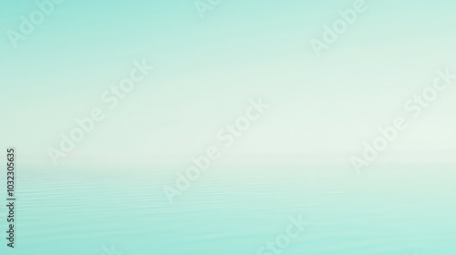 A serene, minimalist image of a soft, blue and green gradient, resembling a calm, hazy sky reflecting on a still body of water.