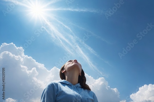 Wallpaper Mural Caucasian woman in blue hoodie gazing at sun blue sky evoking hope and optimism Torontodigital.ca