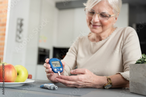 Фотография Woman using blood glucose meter, diabetes test