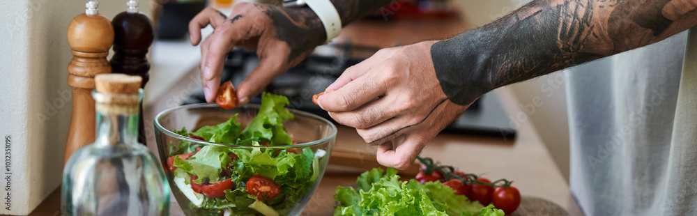 A young, handsome man skillfully mixes fresh vegetables in a bowl while cooking at home. A young, handsome man skillfully mixes fresh vegetables in a bowl while cooking at home.
