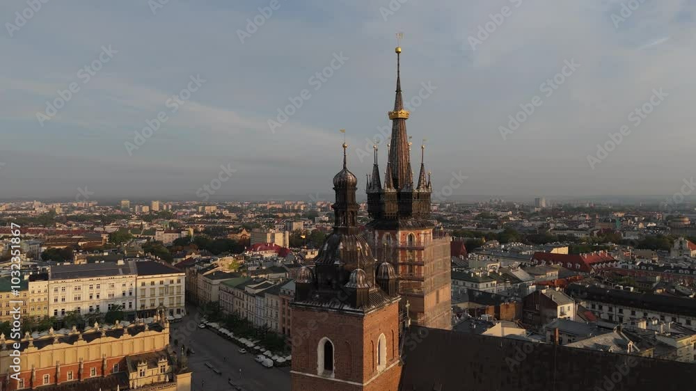 Aerial view of the Church of the Assumption of the Blessed Virgin Mary Bazylika Mariacka on the Market Square in the central historical tourist part of Krakow at sunset, Poland Aerial view of the Church of the Assumption of the Blessed Virgin Mary Bazylika Mariacka on the Market Square in the central historical tourist part of Krakow at sunset, Poland