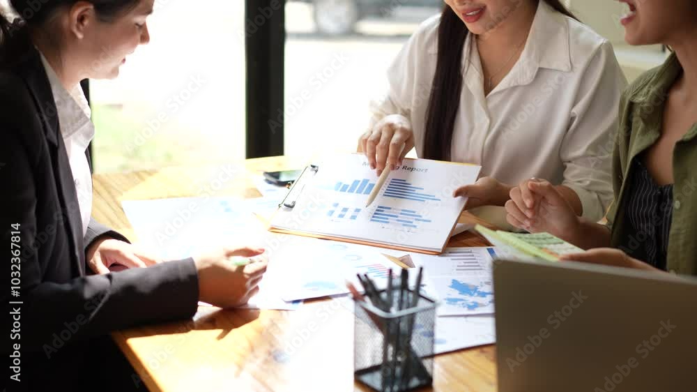 Business Meeting Professionals Collaborate on Marketing Report with Data Analysis and Charts, Fostering Teamwork and Insightful Discussion. Business Meeting Professionals Collaborate on Marketing Report with Data Analysis and Charts, Fostering Teamwork and Insightful Discussion.