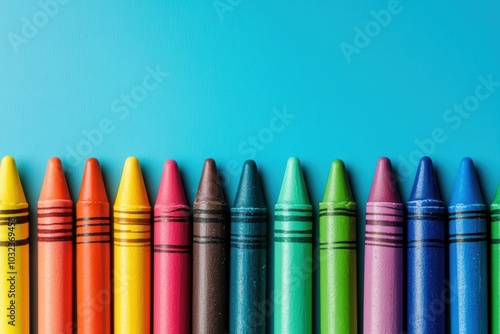 Colorful crayons forming a bottom border on a blue background