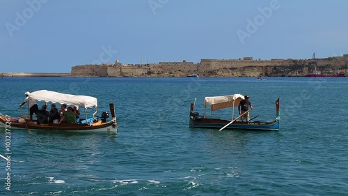 Valletta, Malta - September 26 2024: Tourist boats sailing off the coast of Valletta, Malta