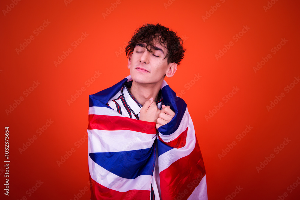 Funny young man posing in studio with flag. Funny young man posing in studio with flag.