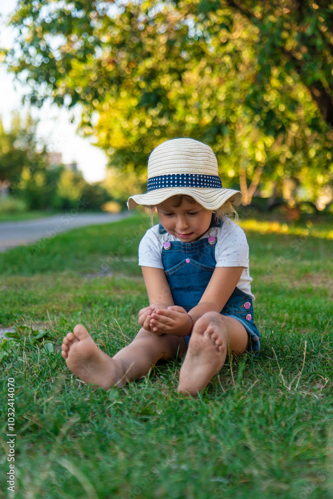 A child looks through a magnifying glass in nature. Selective focus. A child looks through a magnifying glass in nature. Selective focus.