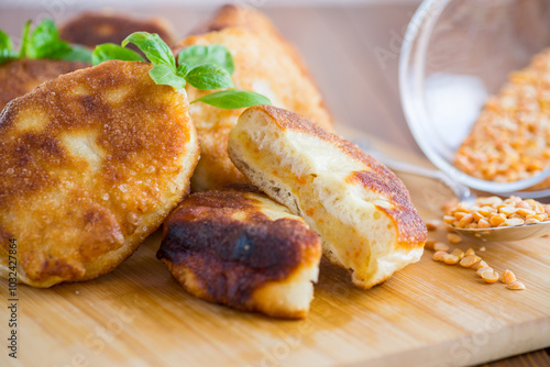 cooked fried pea pies on a wooden board