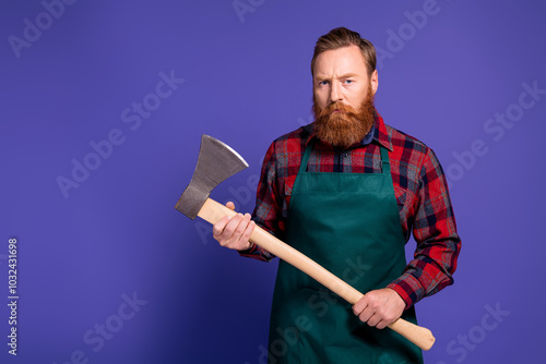 Photo of angry mad killer man wear red checkered shirt hold steel sharp ax isolated on purple color background