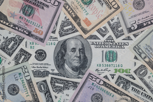 different US dollar banknotes background