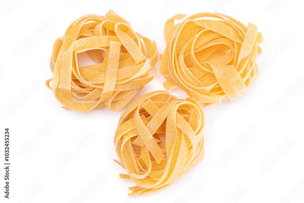 Three Classic Italian Raw Egg Fettuccine - Isolated on White Background. Dry Twisted Uncooked Pasta. Italian Culture and Cuisine. Raw Golden Macaroni Pattern - Isolation Three Classic Italian Raw Egg Fettuccine - Isolated on White Background. Dry Twisted Uncooked Pasta. Italian Culture and Cuisine. Raw Golden Macaroni Pattern - Isolation