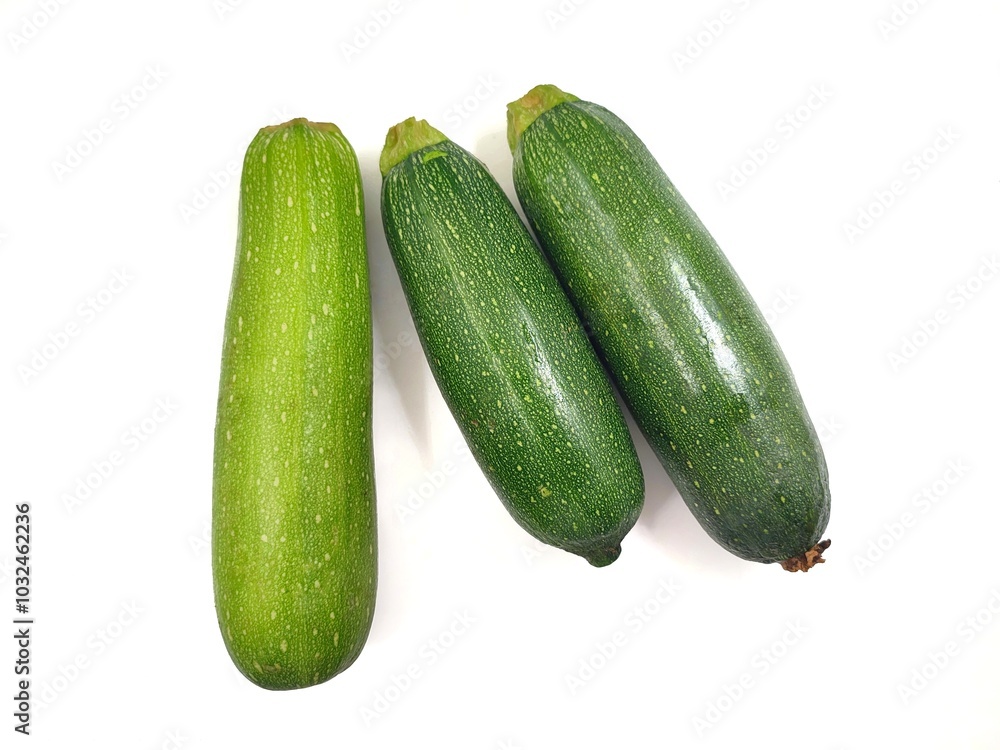 Top view of three fresh zucchinies, also known as courgette or baby marrow (Cucurbita pepo), isolated on a white background. Top view of three fresh zucchinies, also known as courgette or baby marrow (Cucurbita pepo), isolated on a white background.