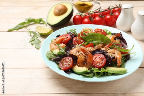 Delicious shrimp salad and ingredients on white wooden table, closeup