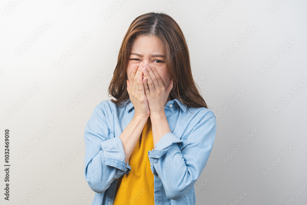 Portrait of pretty brunette hair, disgust smell bad strong asian young woman, girl hand squeezing, covering nose with fingers, expression face disgusting, dislike odor isolated on white background. Portrait of pretty brunette hair, disgust smell bad strong asian young woman, girl hand squeezing, covering nose with fingers, expression face disgusting, dislike odor isolated on white background.