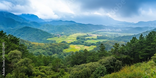 A lush green valley with a mountain in the background. The sky is cloudy and the sun is shining through the clouds