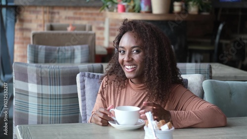 Portrait of a happy mixed race girl. Smiling millennial woman posing indoors. Pretty positive businesswoman student, young professional, looking at camera