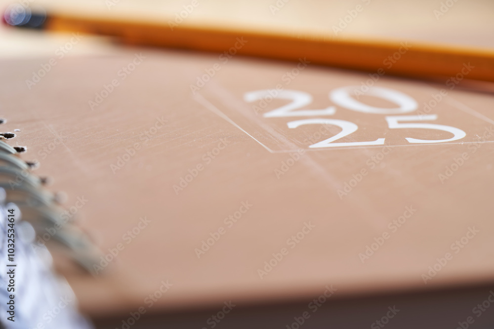 2025 brown diary with pencil on top of wood table 2025 brown diary with pencil on top of wood table