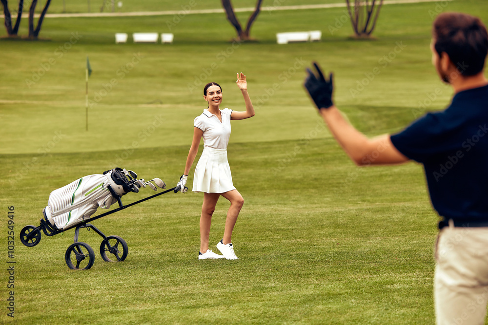 Obraz premium A Friendly Encounter on the Golf Course A Golfer Waves Hello and Greets Another Golfer