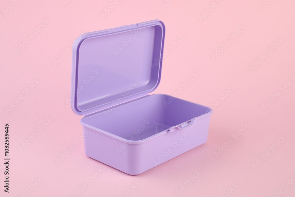 Empty plastic lunch box on light pink background Empty plastic lunch box on light pink background