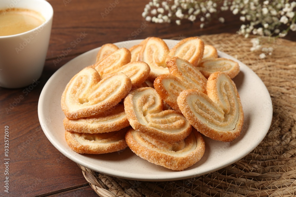 Delicious palmier cookies with coffee on wooden table Delicious palmier cookies with coffee on wooden table
